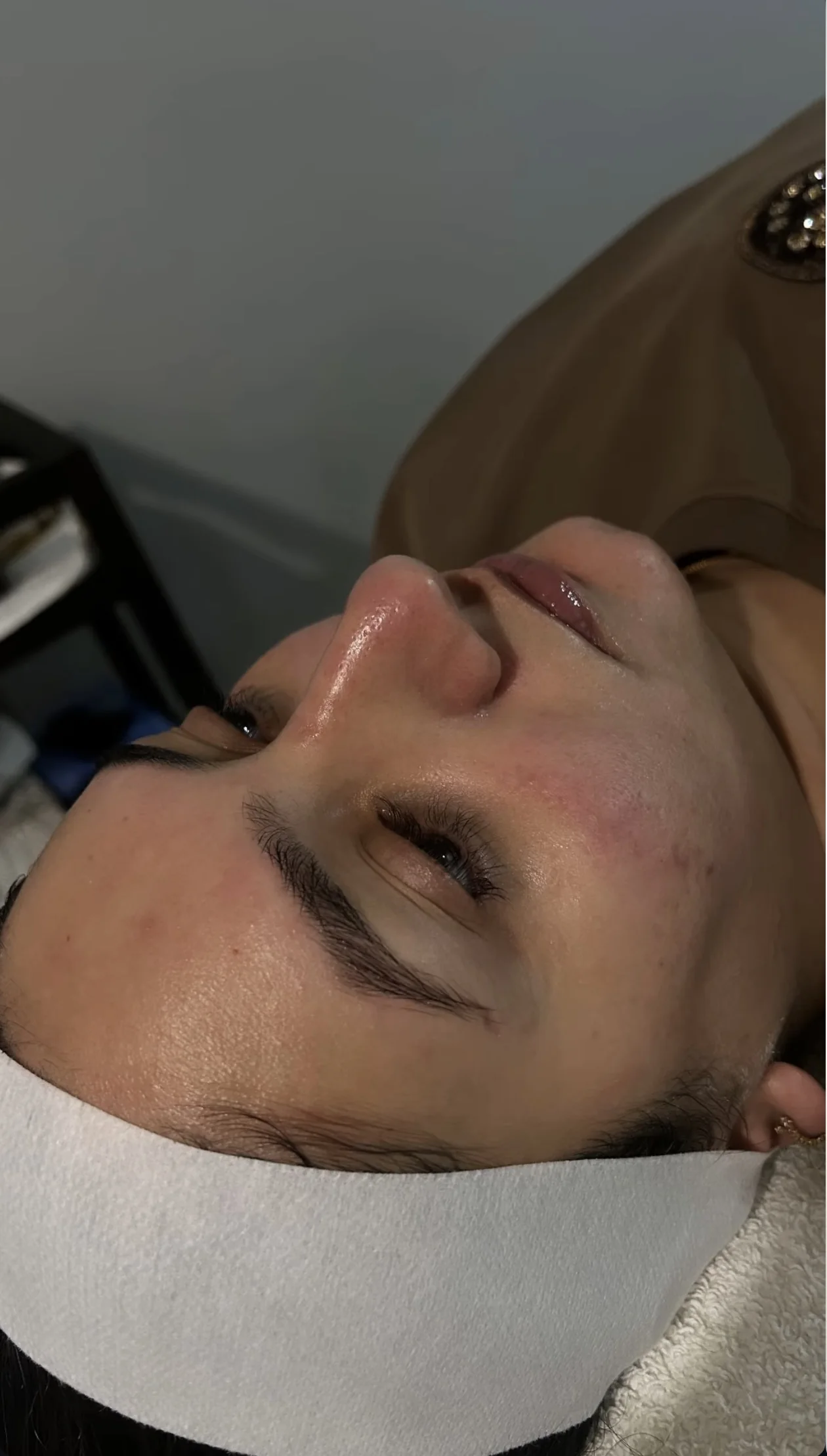 A client relaxing during skin care at Mac Esthetics