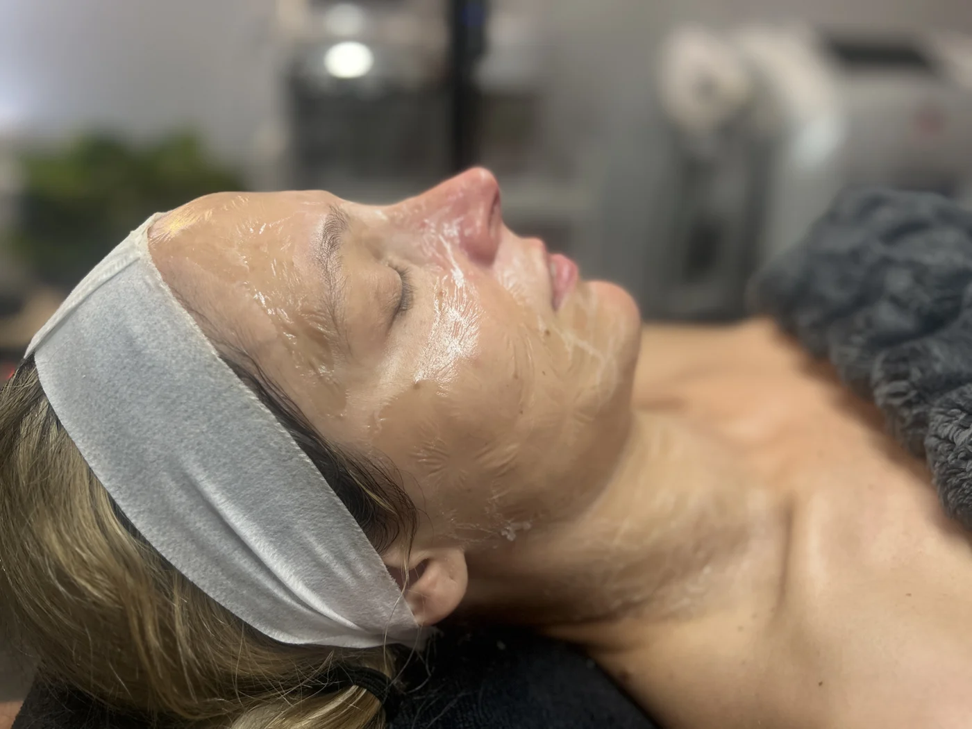 Client resting during facial care at Mac Esthetics